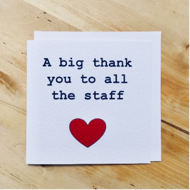 A note card with the words thank you to staff and a heart symbol