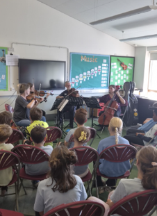 Four musicians playing violin and cello