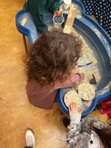 Child playing in sand pit