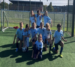 Group of girls in front of football goal