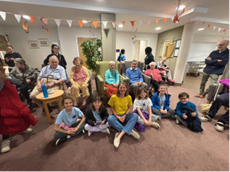 Children sitting on the floor in an an elderly care home
