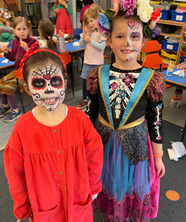 Two children in mexican dress and face paint