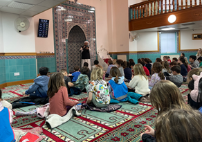 People inside a mosque sitting on the floor