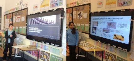 Pupils standing in front of screen giving a presentation
