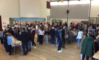 School hall with people looking at an exhibition