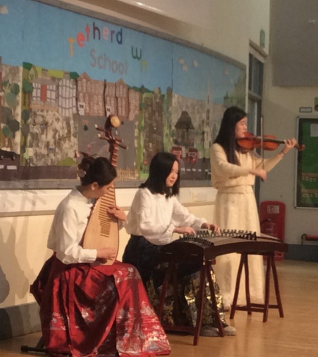 Three women playing Chinese instruments