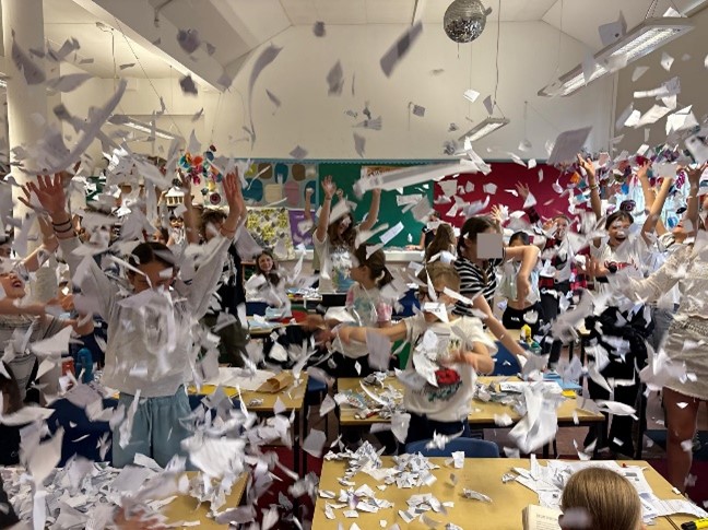 Lots of paper flying in the air after being thrown in celebration