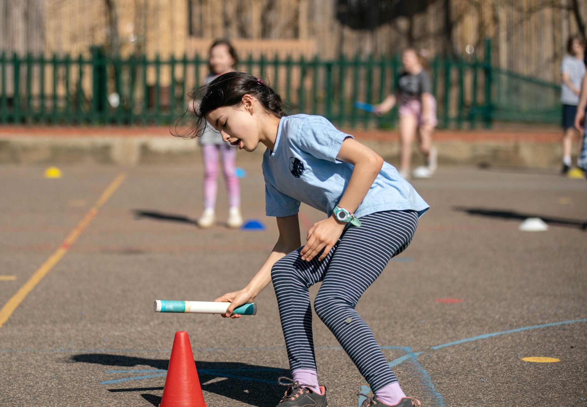 Pupil running with baton